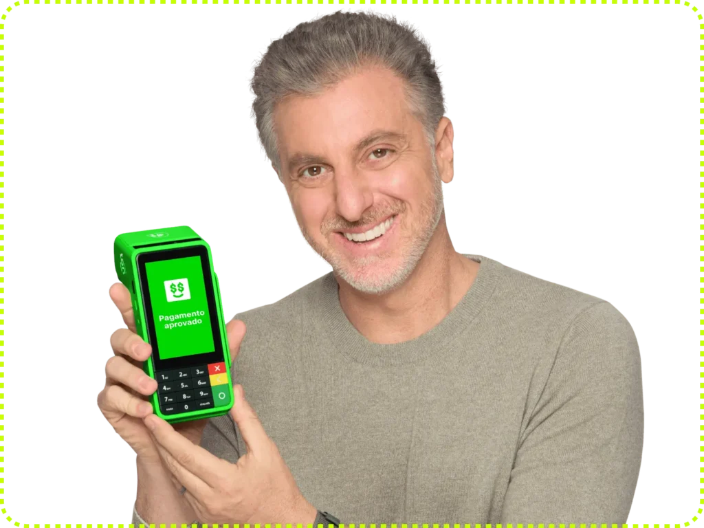 Luciano Huck segurando a maquininha T3 Smart da Ton